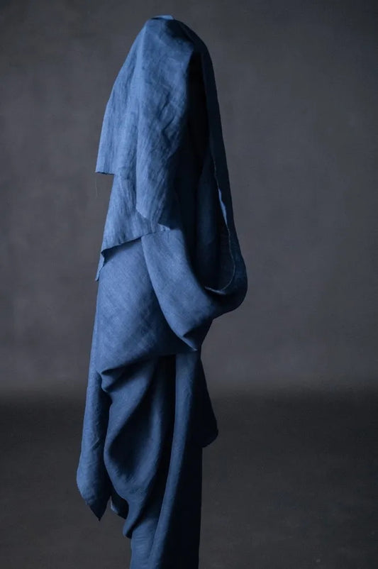 Blue fabric draped over a dark gray background