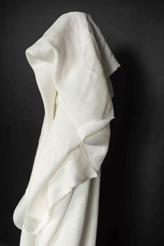 White draped fabric on a black background