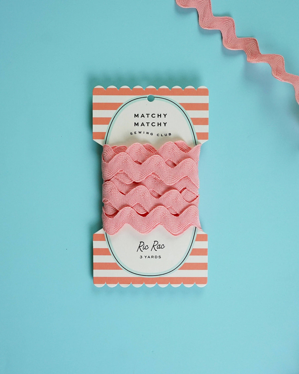 Pack of pink ribbon with striped packaging on a blue background