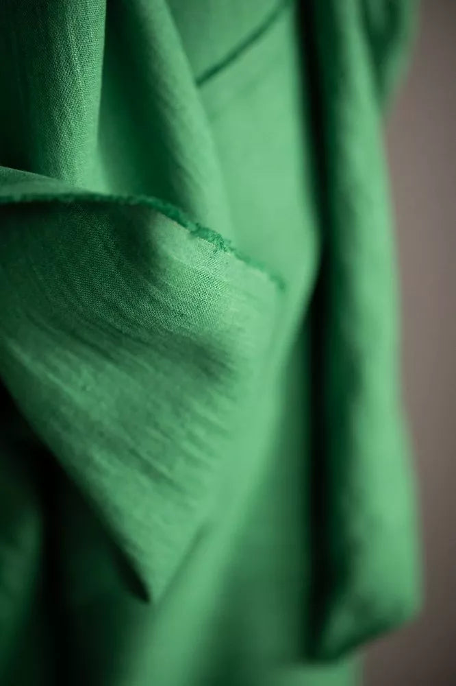 Close-up of green fabric with a blurred background