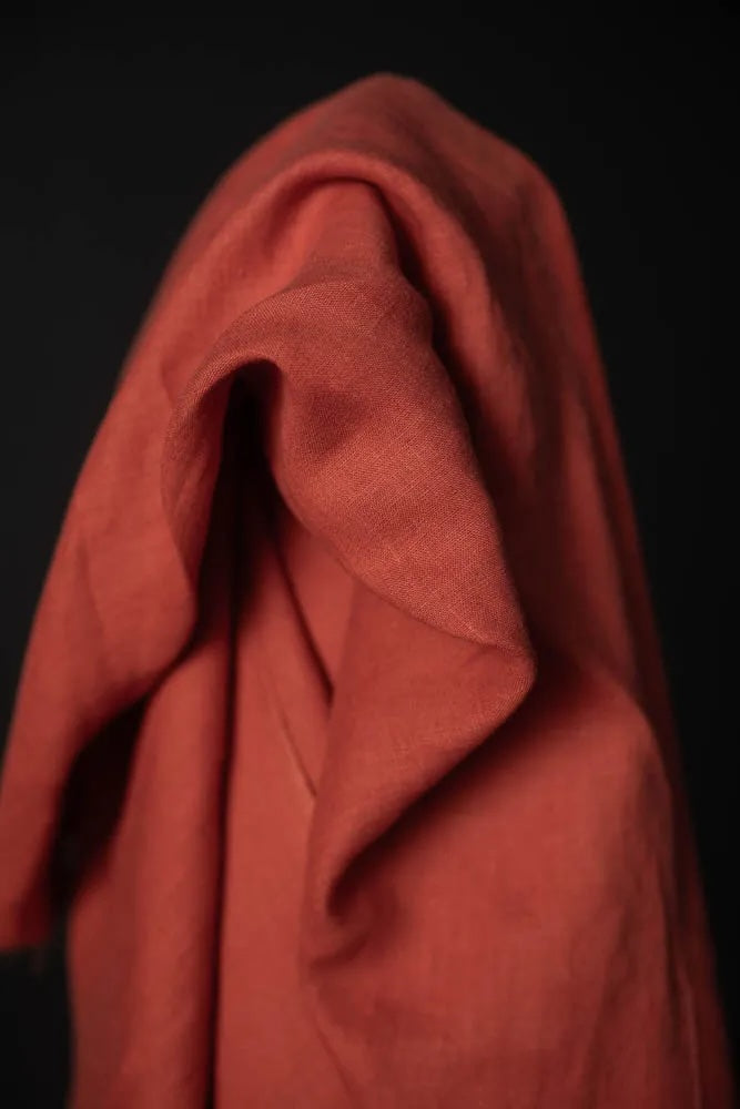 Red fabric draped over a black background