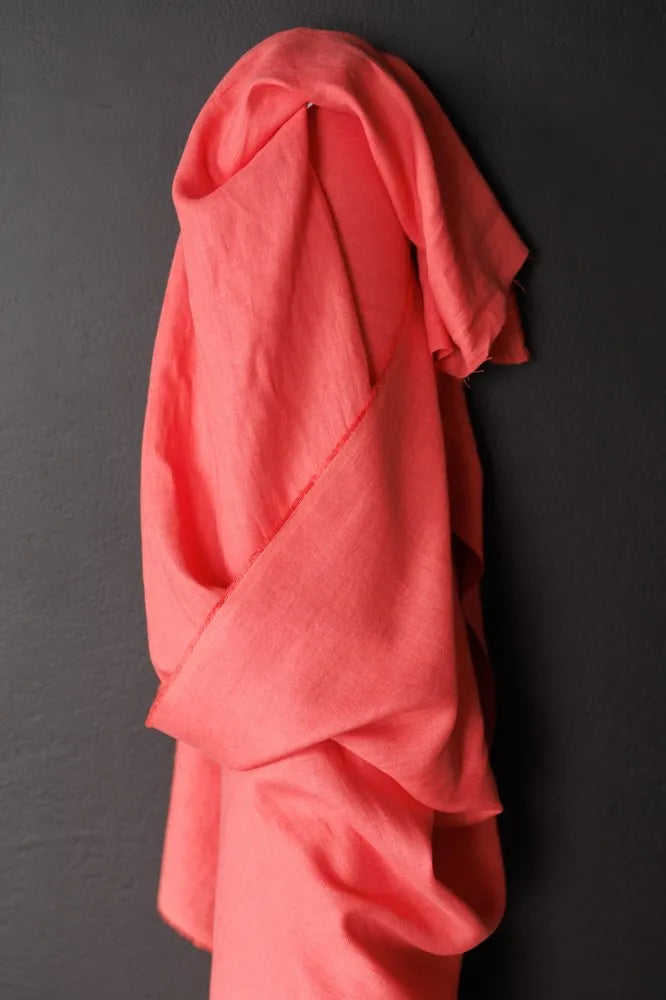 Pink garment draped over a black surface
