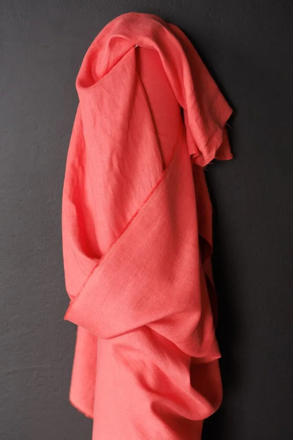 Pink garment draped over a black surface