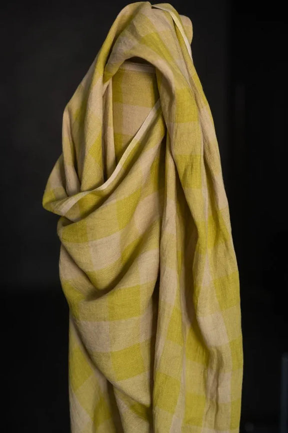 Yellow and white checkered fabric draped over a black background