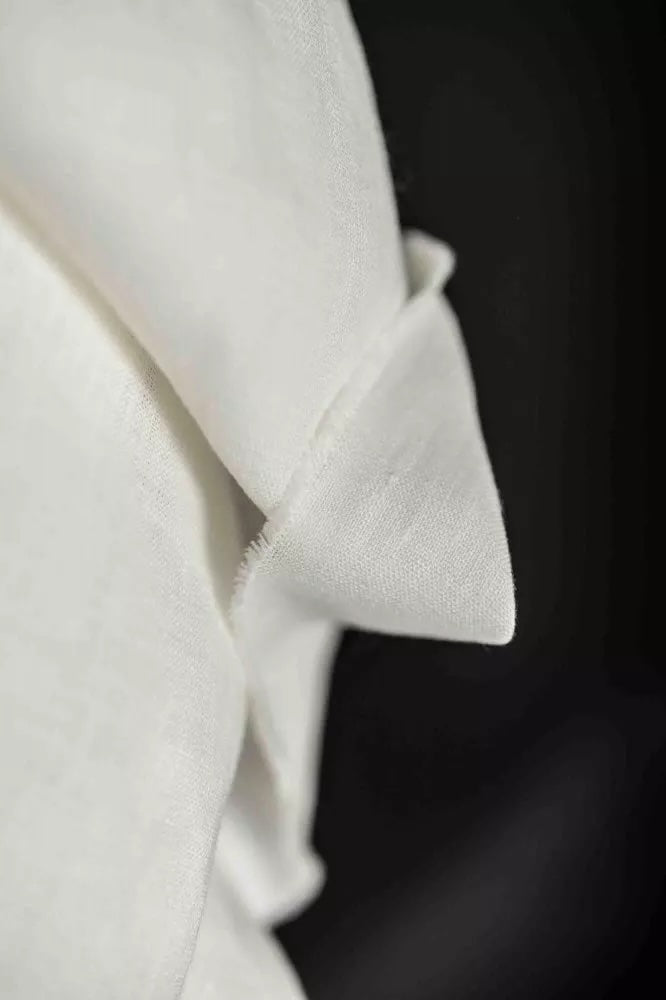 Close-up of a white fabric with a dark background