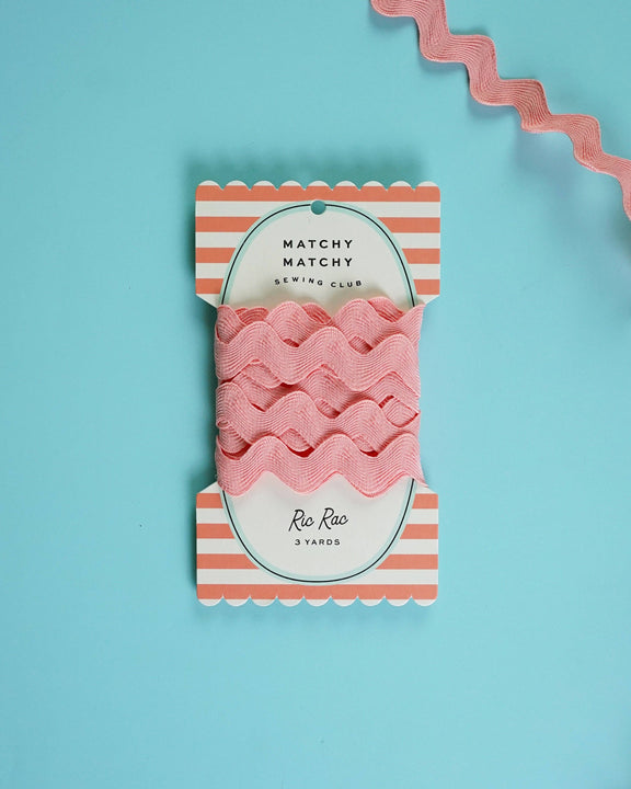 Pack of pink ribbon with striped packaging on a blue background
