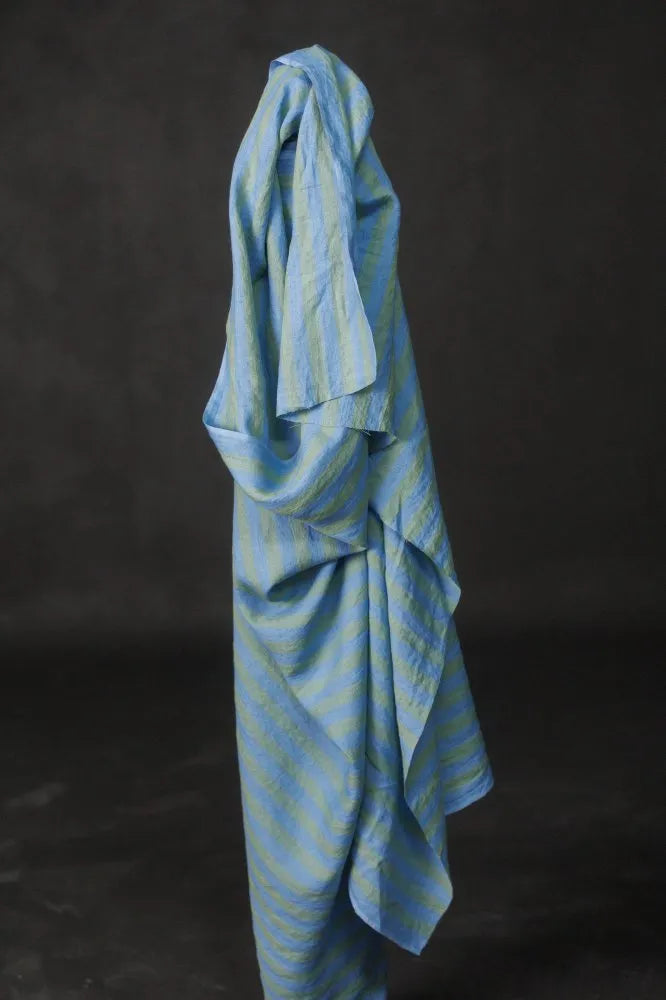 Blue striped towel draped over a black background