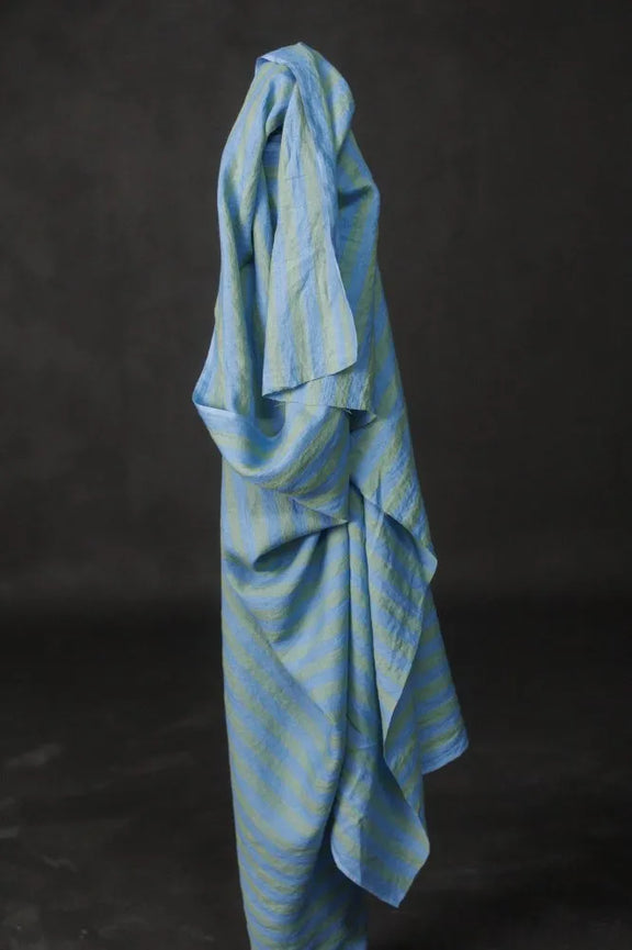 Blue striped towel draped over a black background